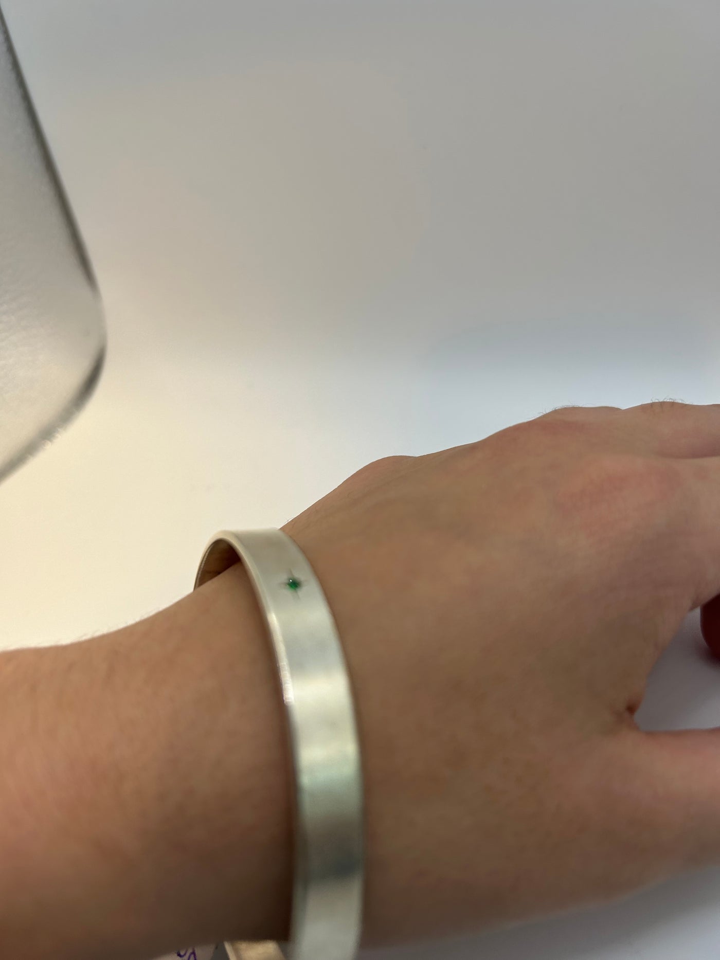 Silver solid bracelet with four cubic zirconias engraved