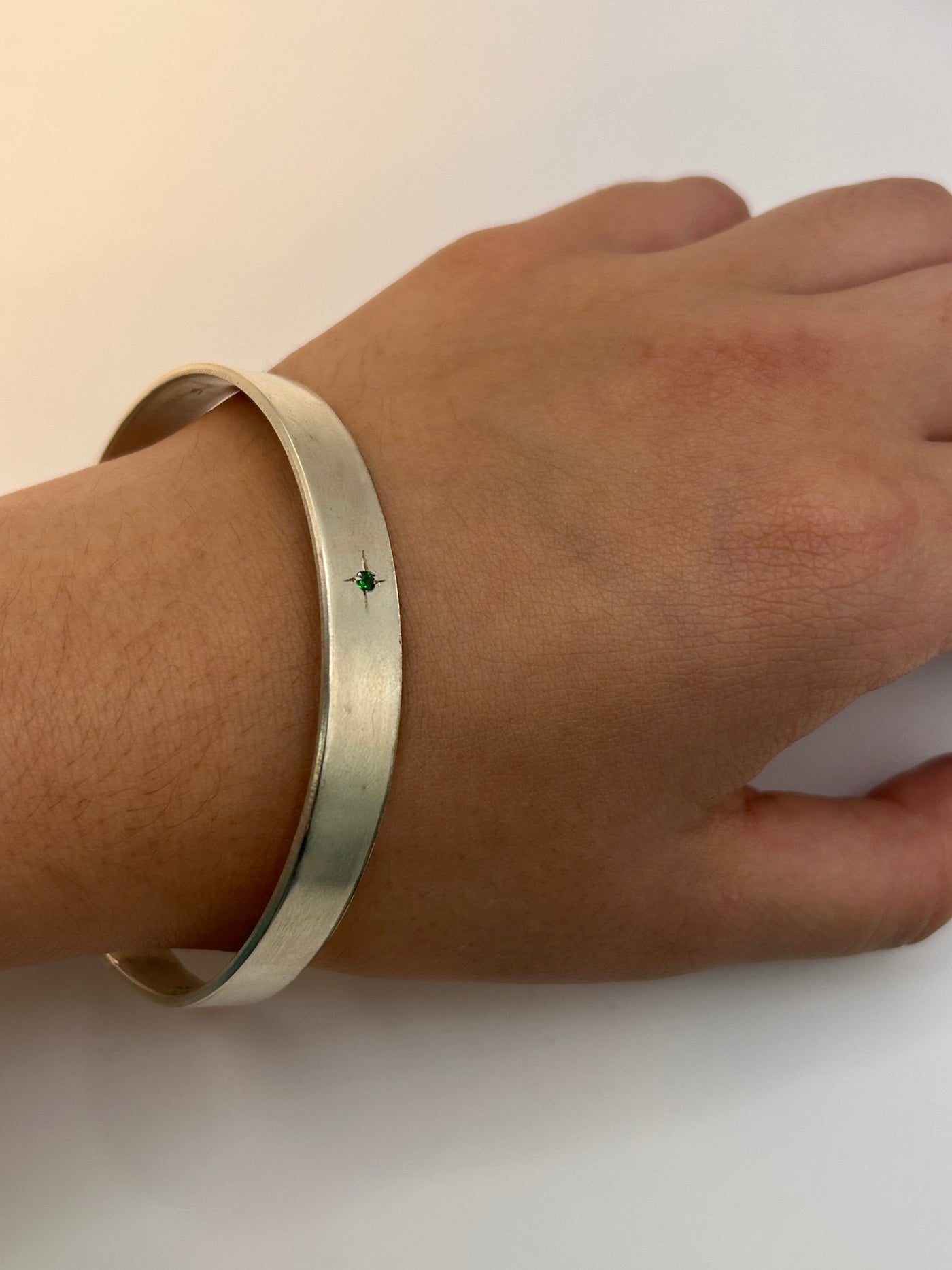 Silver solid bracelet with four cubic zirconias engraved