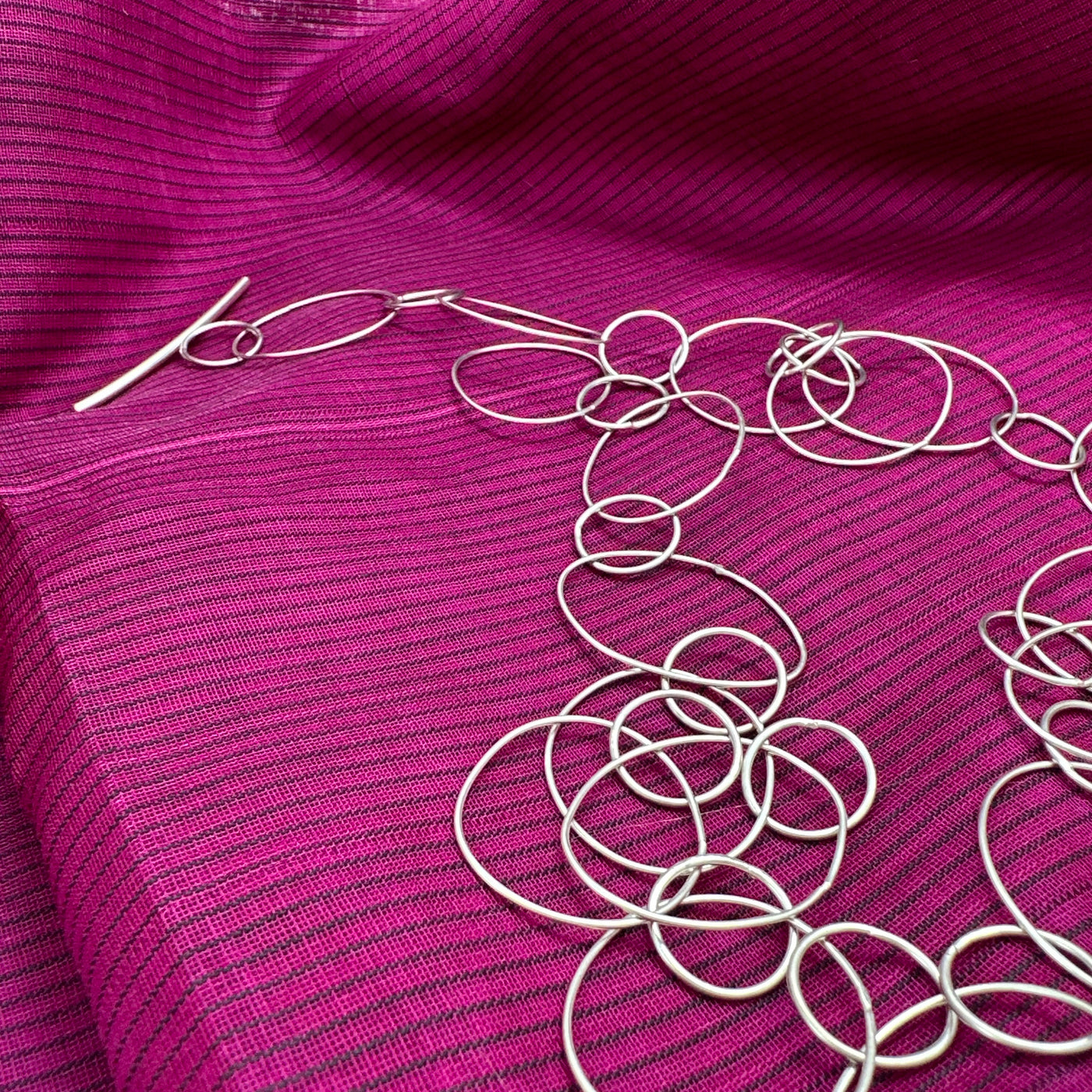 Sterling silver necklace featuring ovals and circles and a linear closure