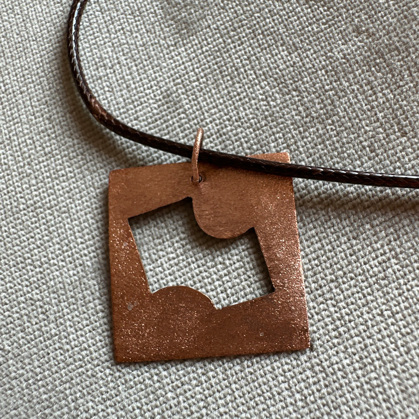 Copper geometry pendant on cord