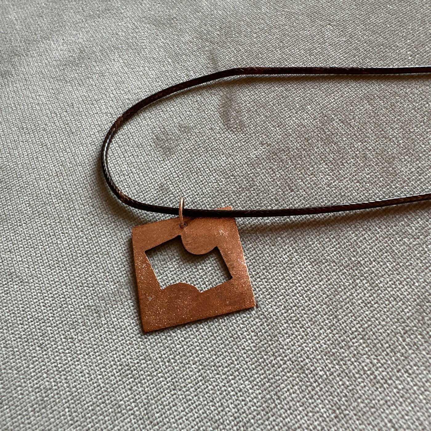 Copper geometry pendant on cord