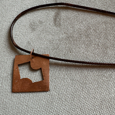 Copper geometry pendant on cord