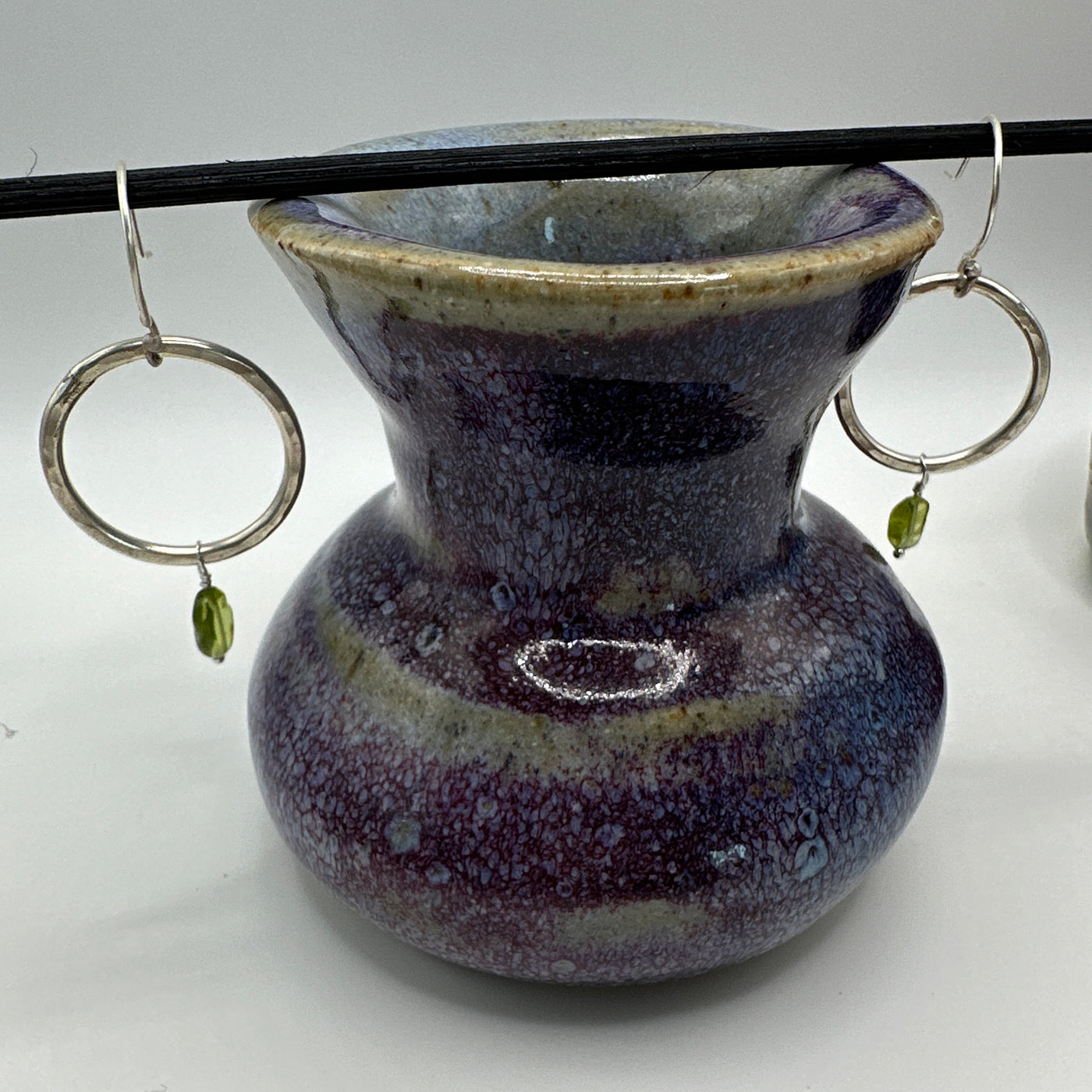 Silver round rings and oval peridot earrings
