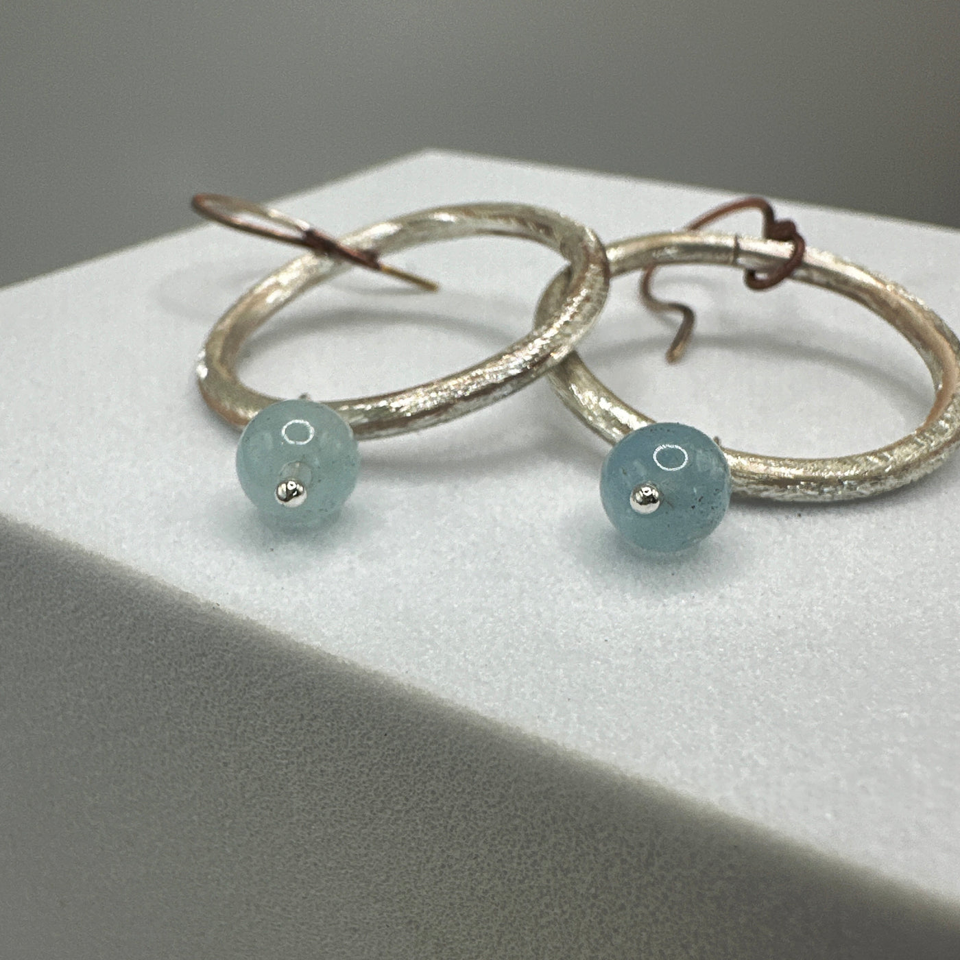 Silver round rings and aquamarine earrings