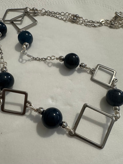 Necklace featuring brass squares with dark blue jada and steel pearls. Closure in silver handmade