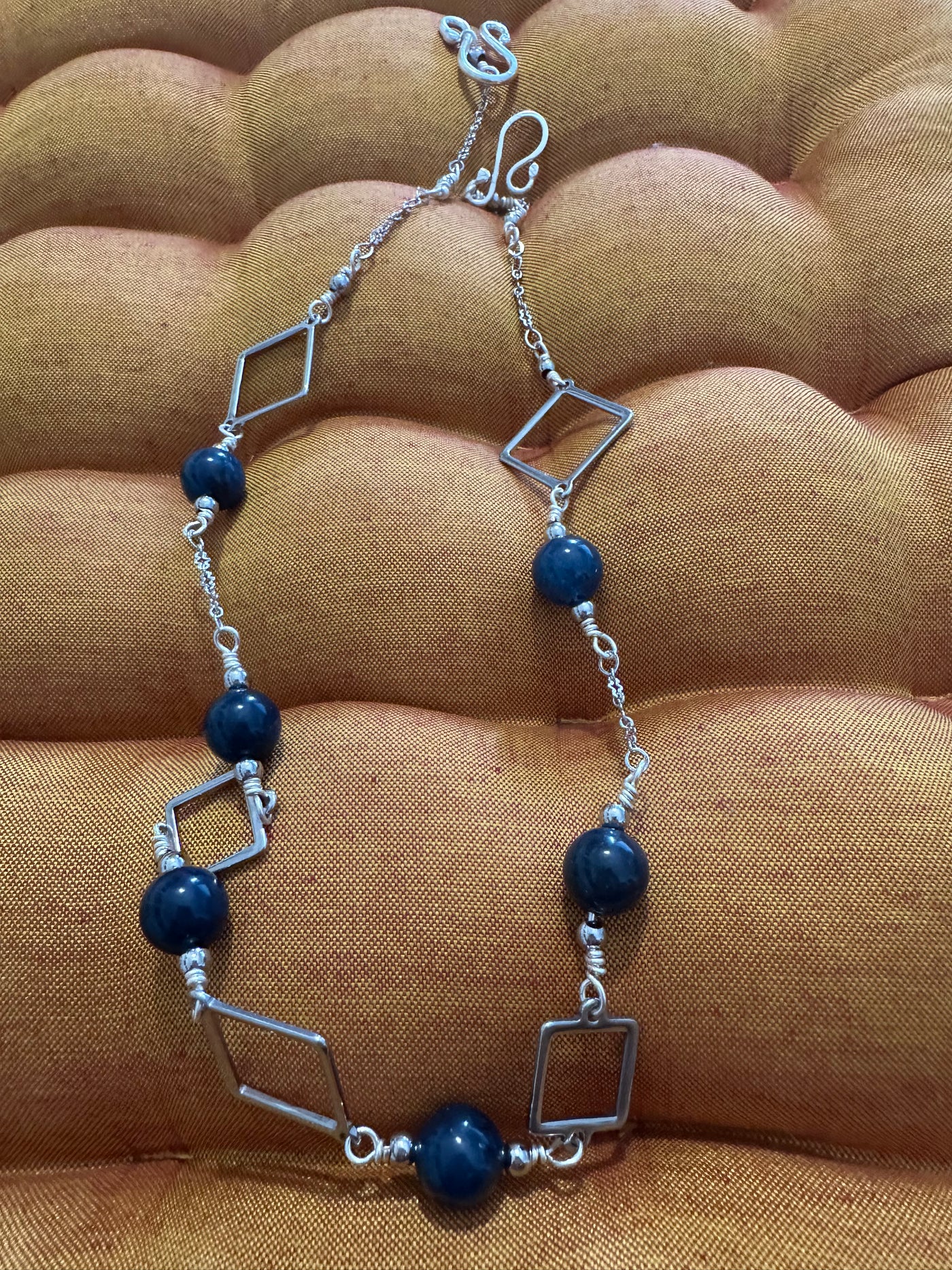 Necklace featuring brass squares with dark blue jada and steel pearls. Closure in silver handmade