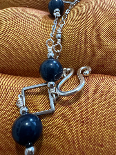 Necklace featuring brass squares with dark blue jada and steel pearls. Closure in silver handmade