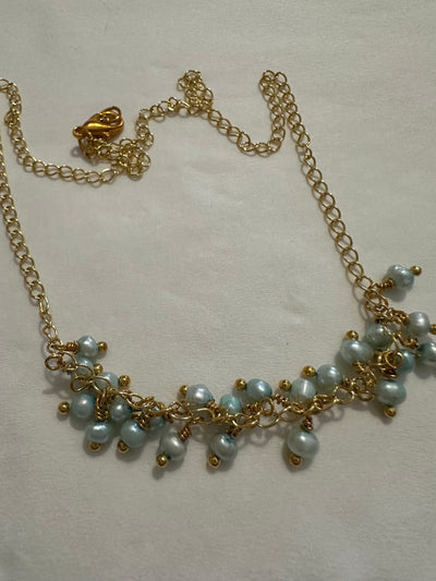 Necklace featuring freshwater pearls -light turquoise- on silver gold plated chain