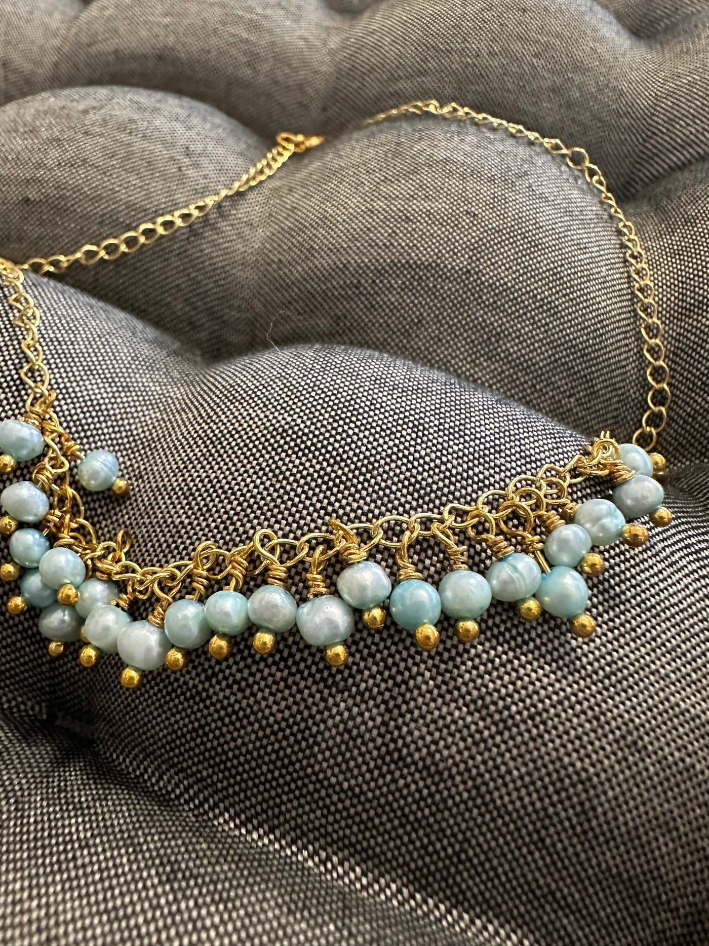 Necklace featuring freshwater pearls -light turquoise- on silver gold plated chain