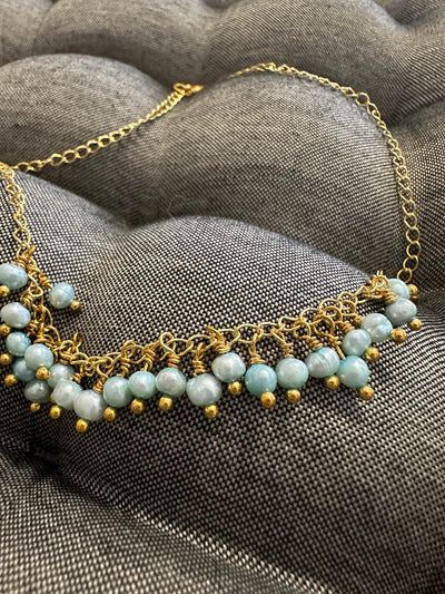 Necklace featuring freshwater pearls -light turquoise- on silver gold plated chain