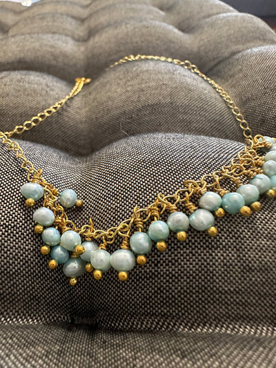 Necklace featuring freshwater pearls -light turquoise- on silver gold plated chain