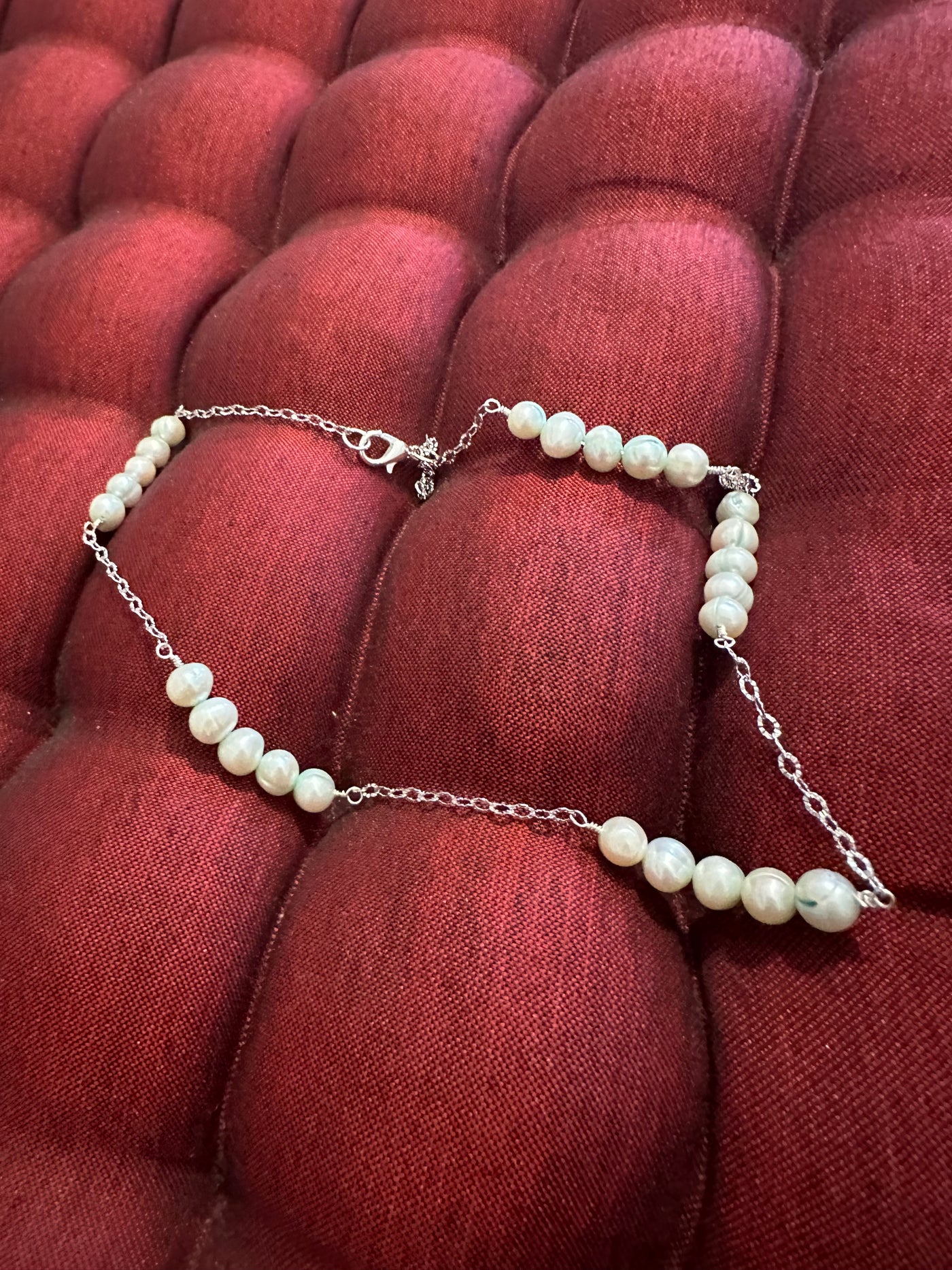 Necklace featuring freshwater pearls -light turquoise- on rhodium plated brass chain