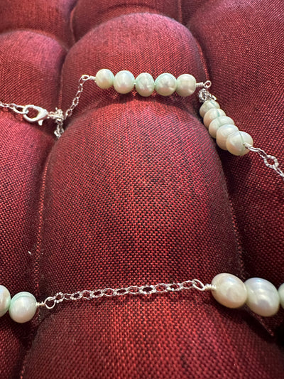 Necklace featuring freshwater pearls -light turquoise- on rhodium plated brass chain