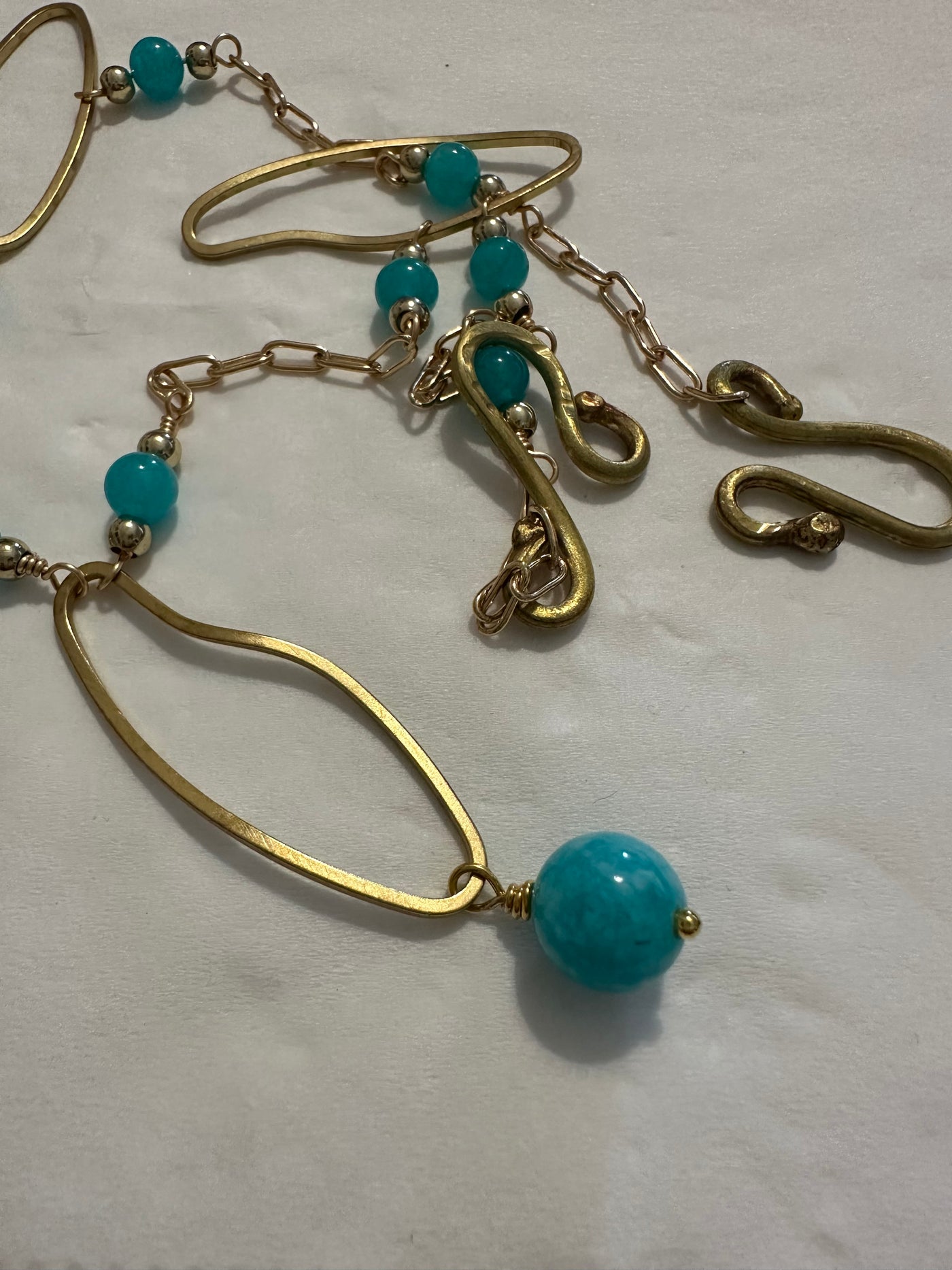 Necklace with bronze oval elements and turquoise jade pearls on  brass chain