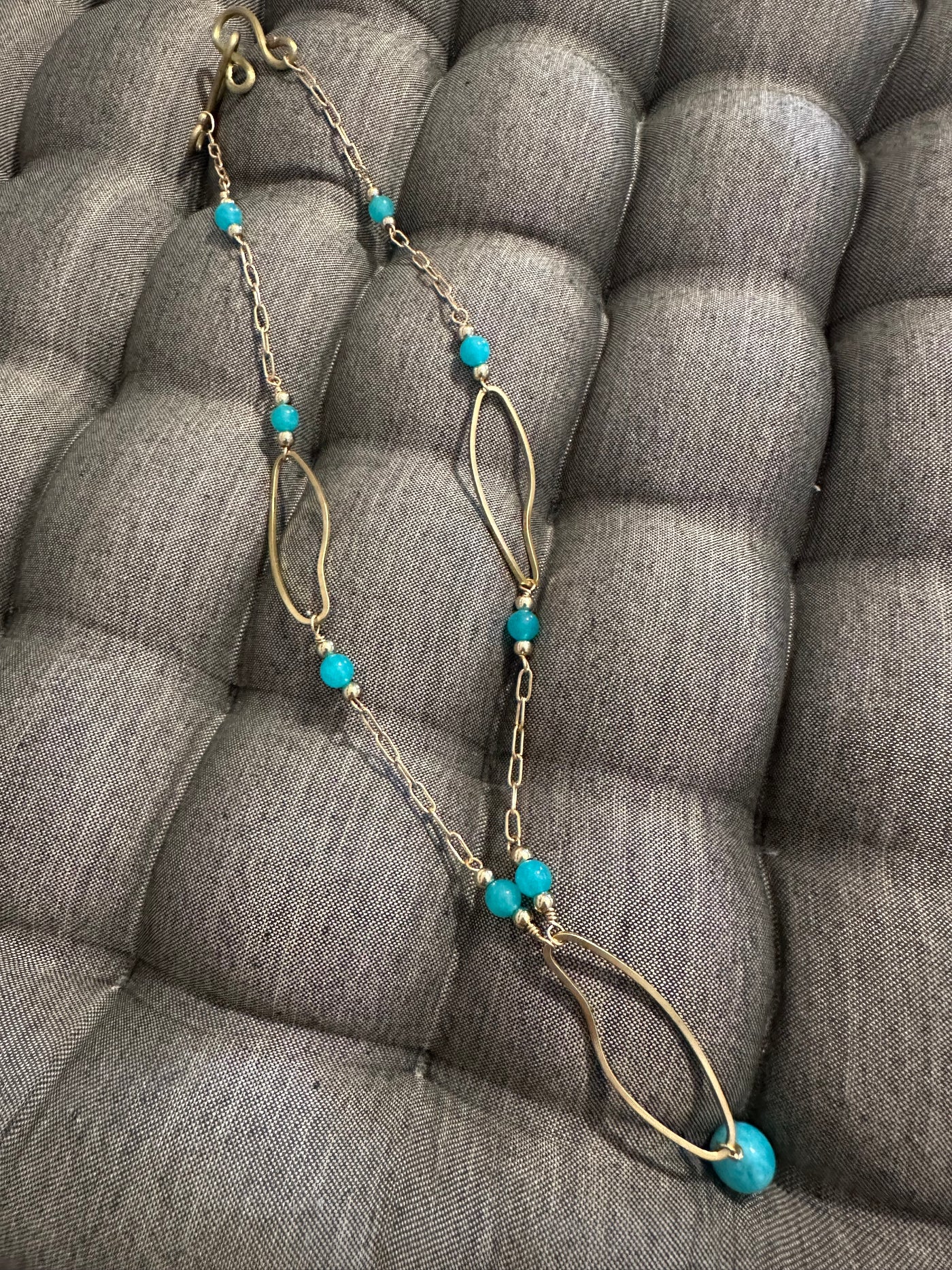 Necklace with bronze oval elements and turquoise jade pearls on  brass chain