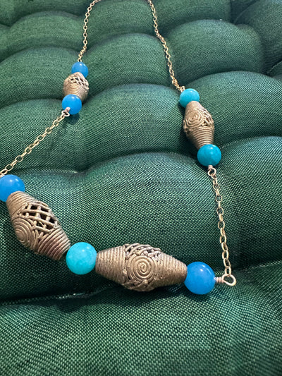 Necklace with brass elements and turquoise jade pearls on brass chain