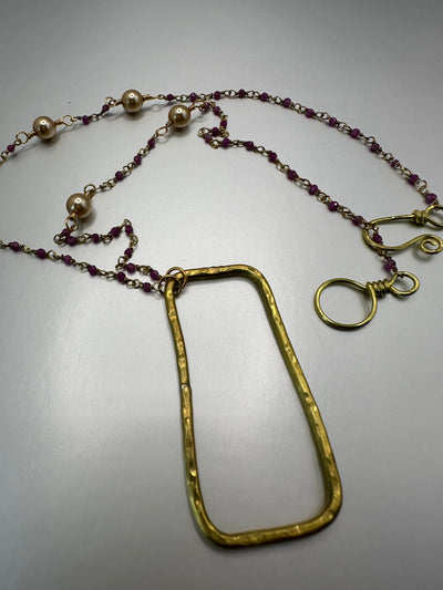 Silver and purple beads with brass rectangular pendant and golden pearls