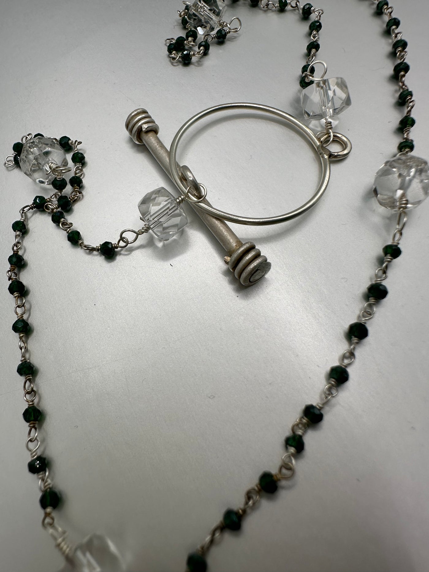 Sterling silver and rock crystals with green beads and handmade Doric closure