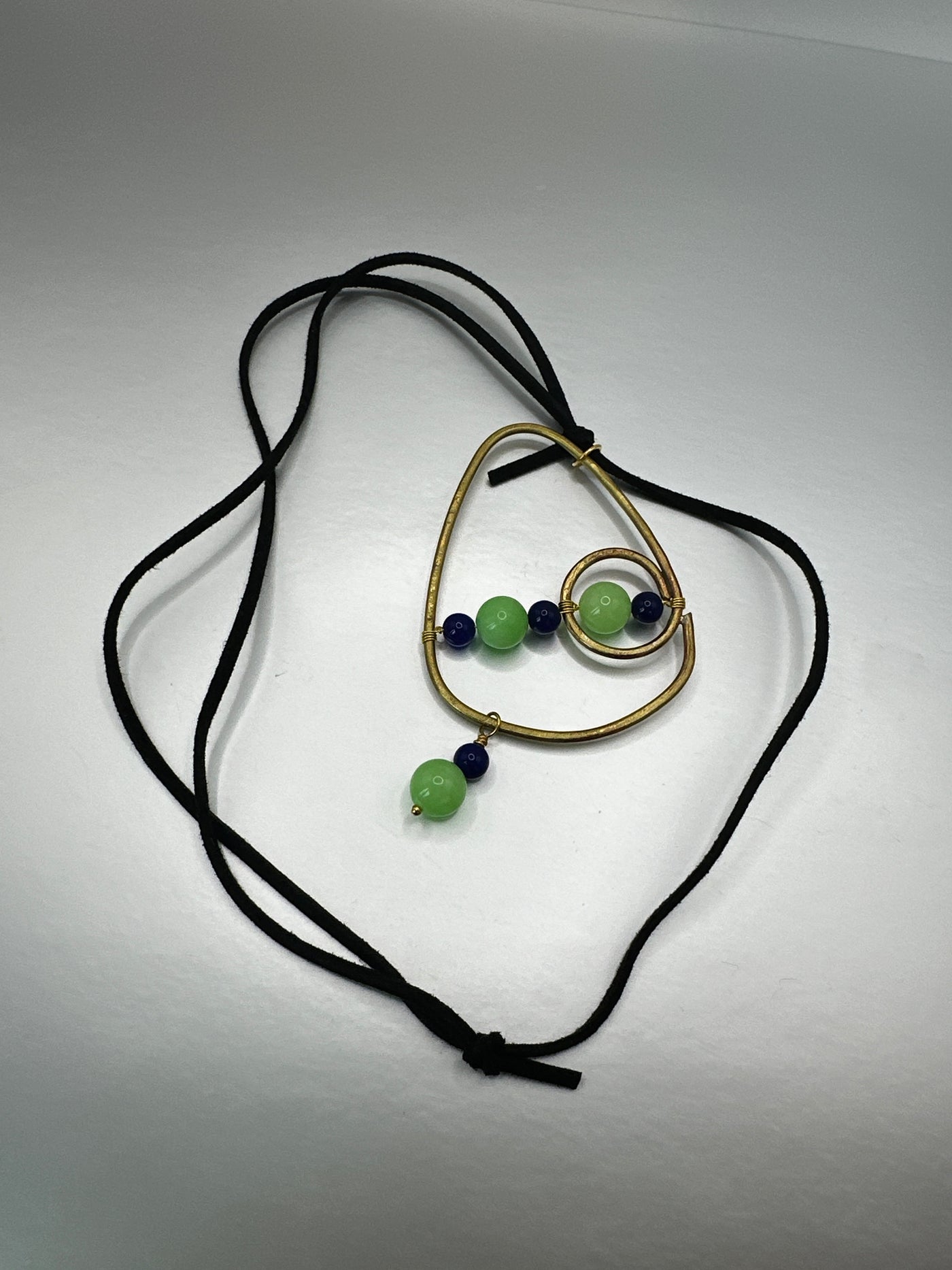 Brass, green and blue jade pendant on black leather