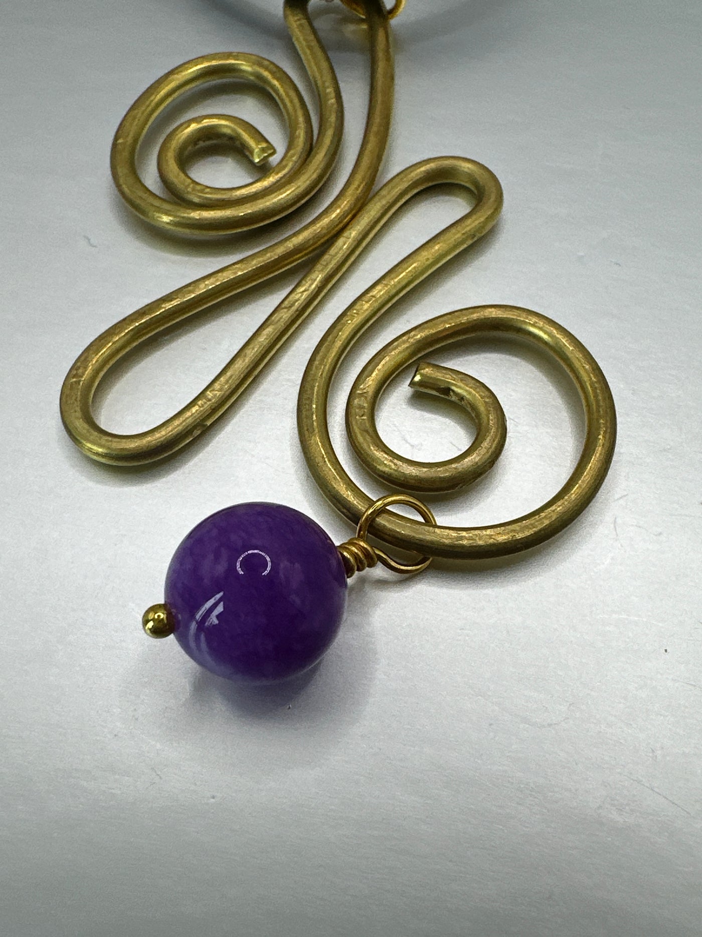 Brass, violet jade pendant on black leather