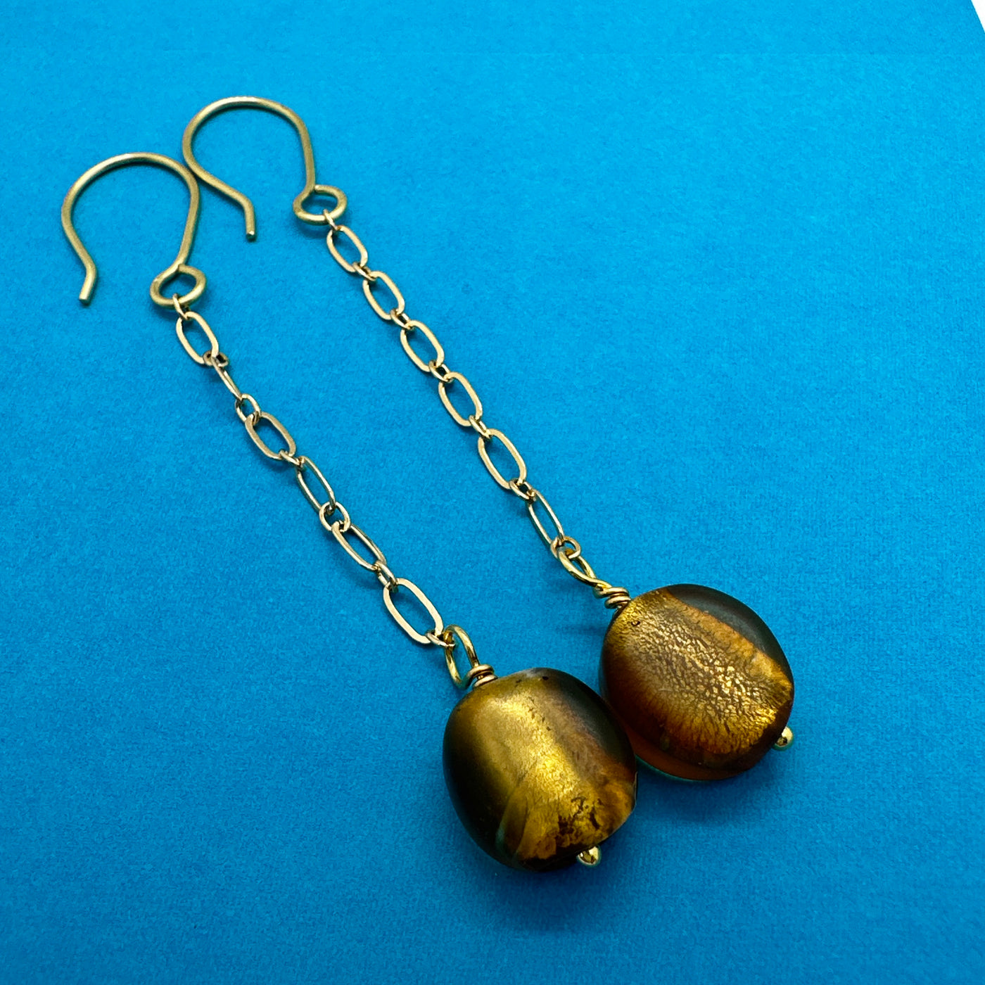 Gold leaf glass pearl attached to brass chain. Earrings are 9 cm long. 6 g