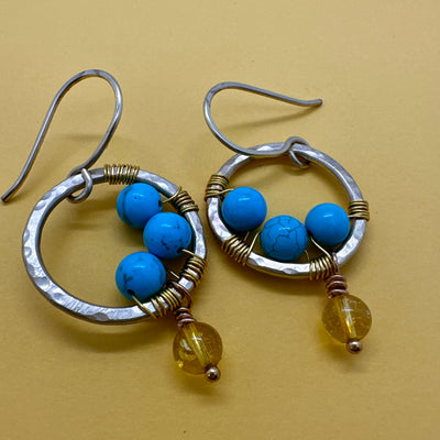 Brass round earrings wrapped with turquoises and with a pending citrine