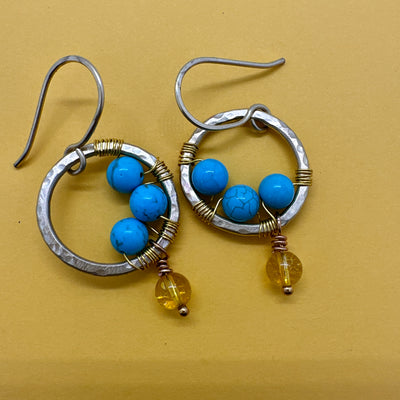Brass round earrings wrapped with turquoises and with a pending citrine