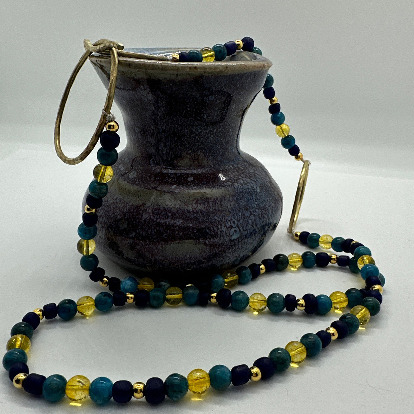 Cytrine, blue glass, blue tiger eyes beads and brass hammered closure
