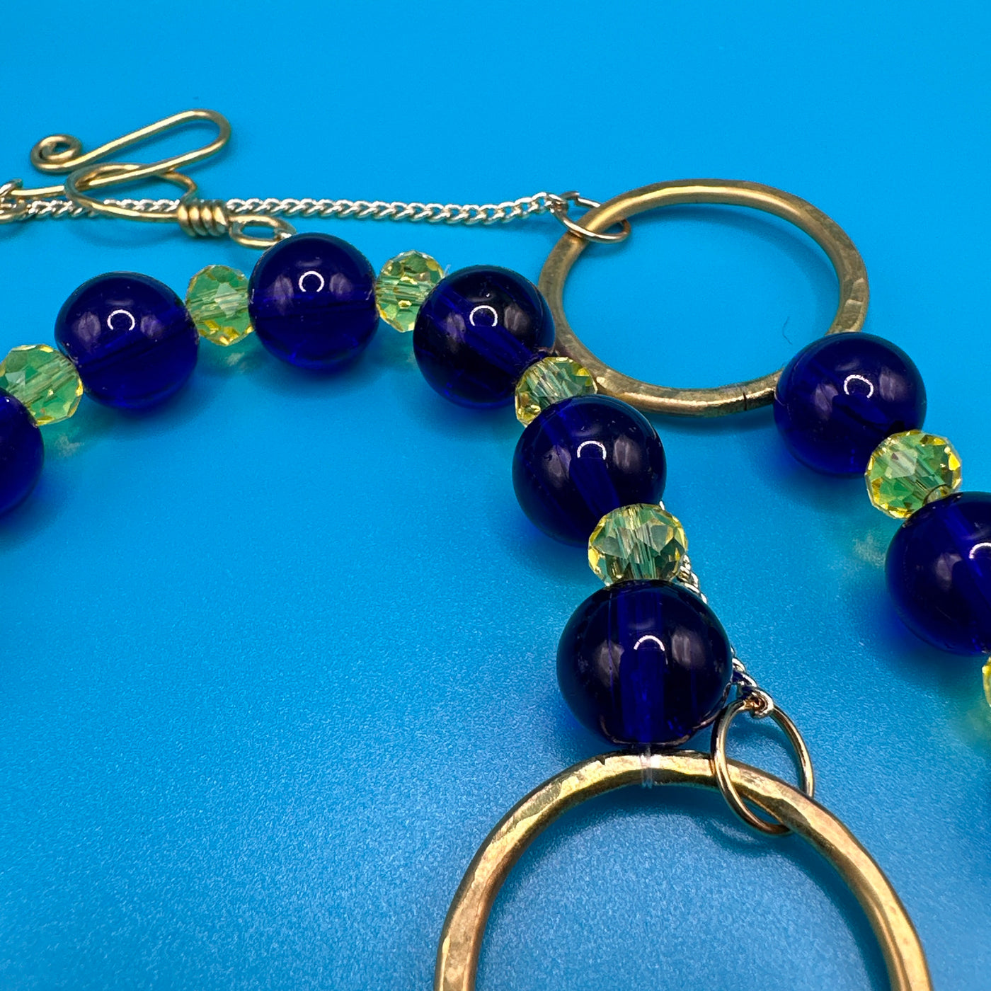 Blue cobalt crystal and yellow crystal rondelles on brass rounds and chain