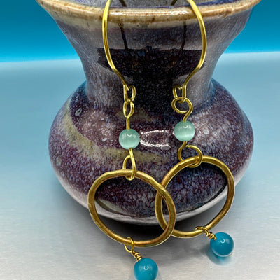 Earrings with dumorterite and celeste blue cats eye and a brass round