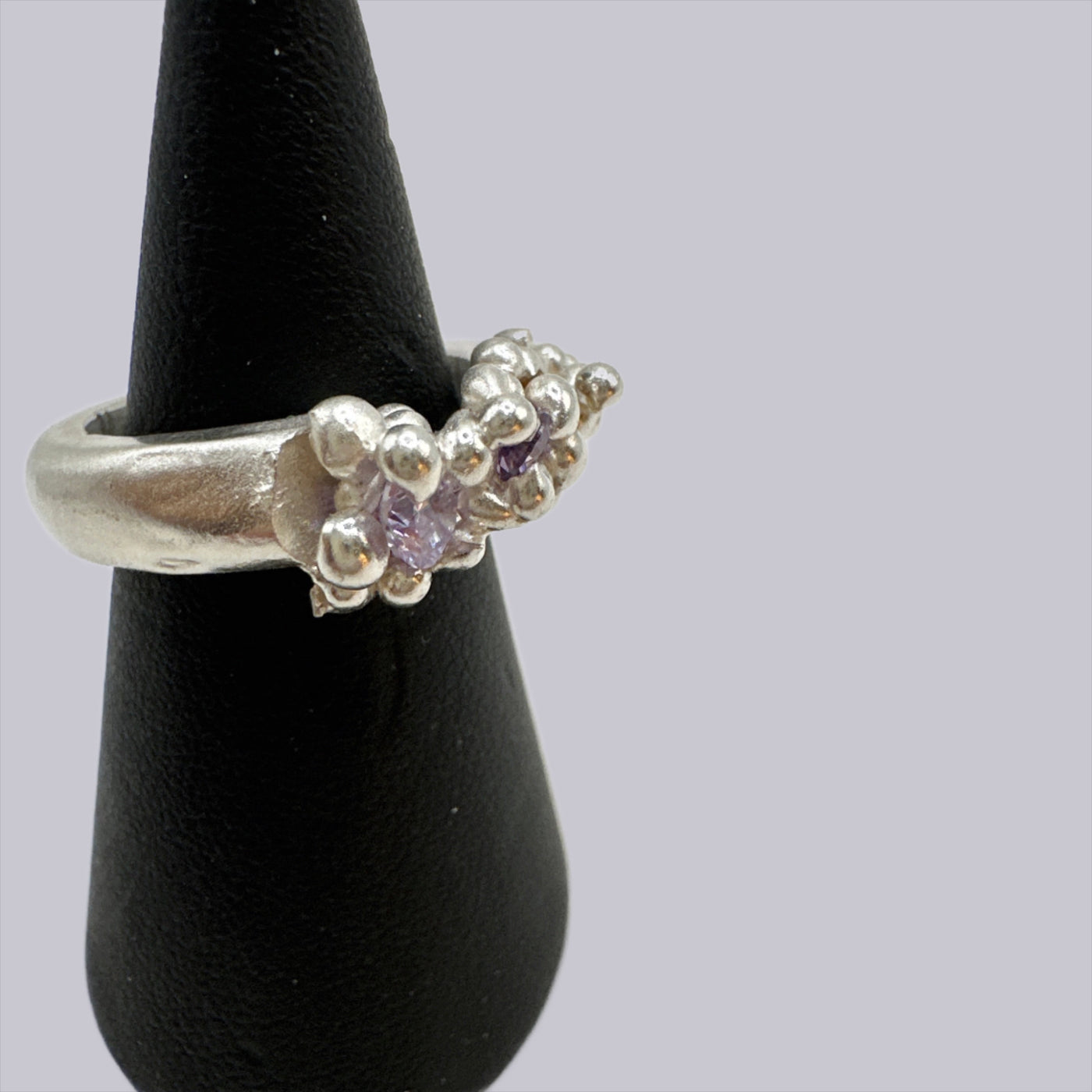 Wax lost granulation silver ring with violet cubic zirconia incapsulated