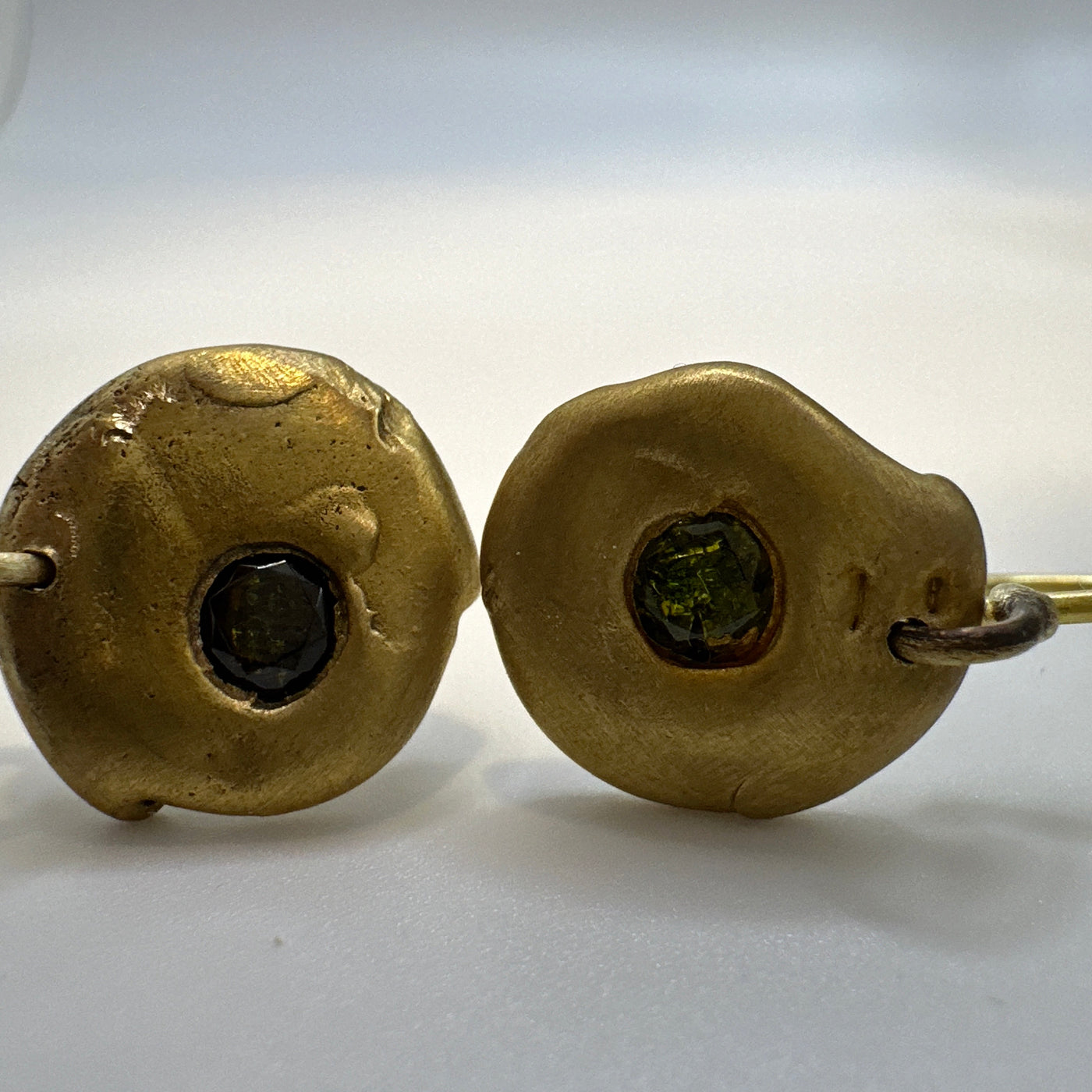 Brass earrings casted from lost wax with green cubic zirconia