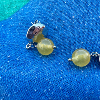 Yellow giada earrings with round silver colored brass elements