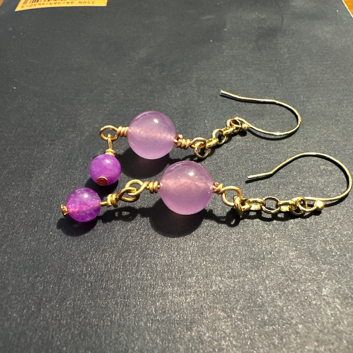 Small and larger purple giada beads on brass earrings