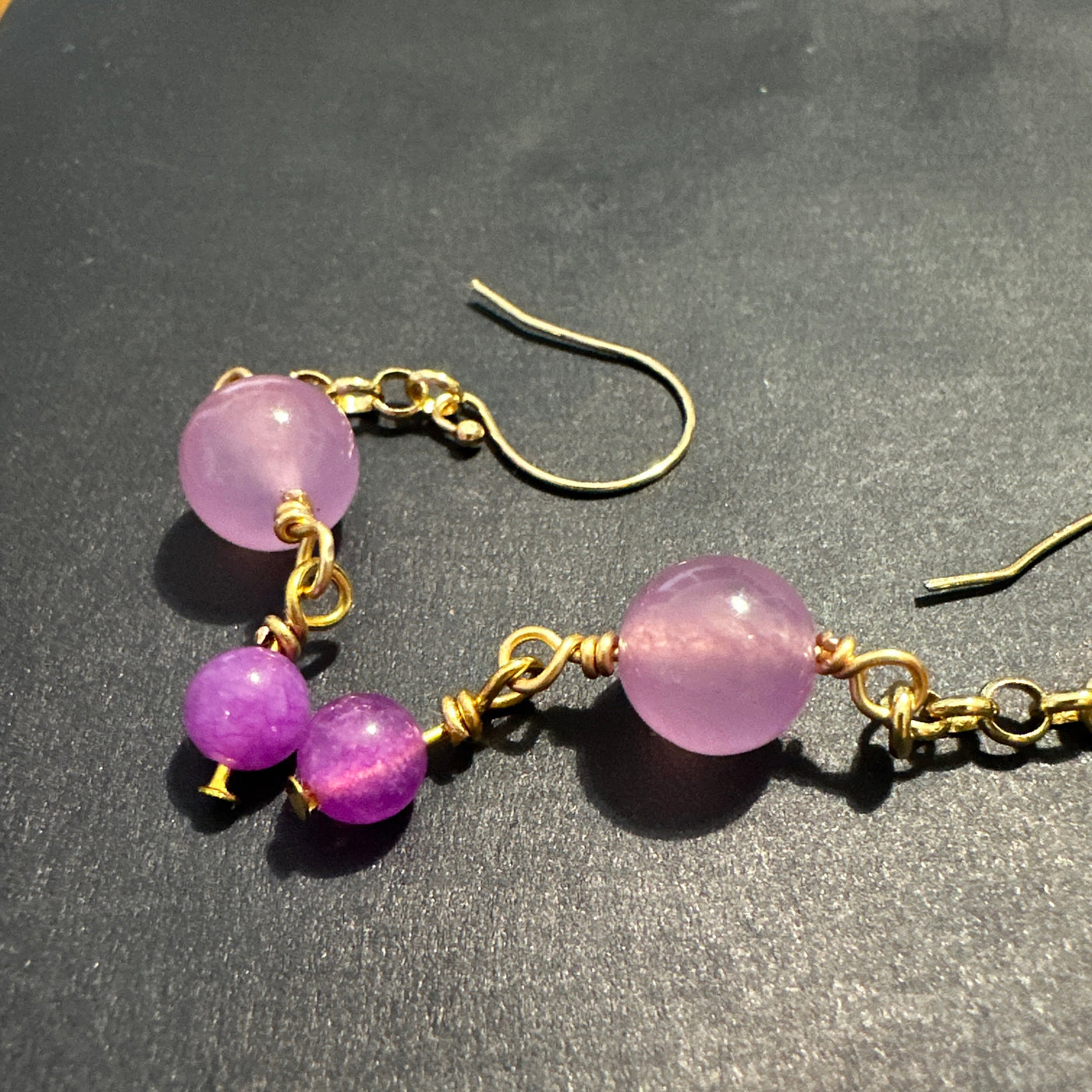 Small and larger purple giada beads on brass earrings