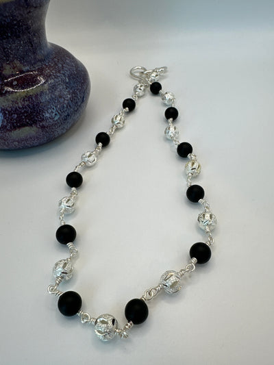 Black satinated onyx and diamond brass spheres necklace