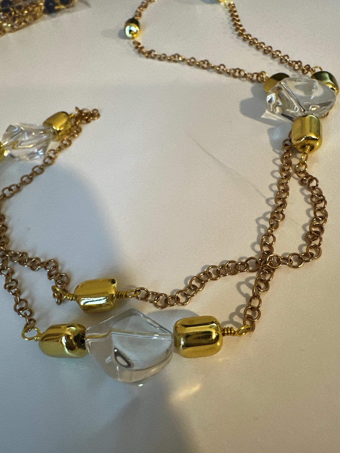 Transparent irregular crystals on 'forzatina' steel gold chain and brass gold elements. Long 74 cm