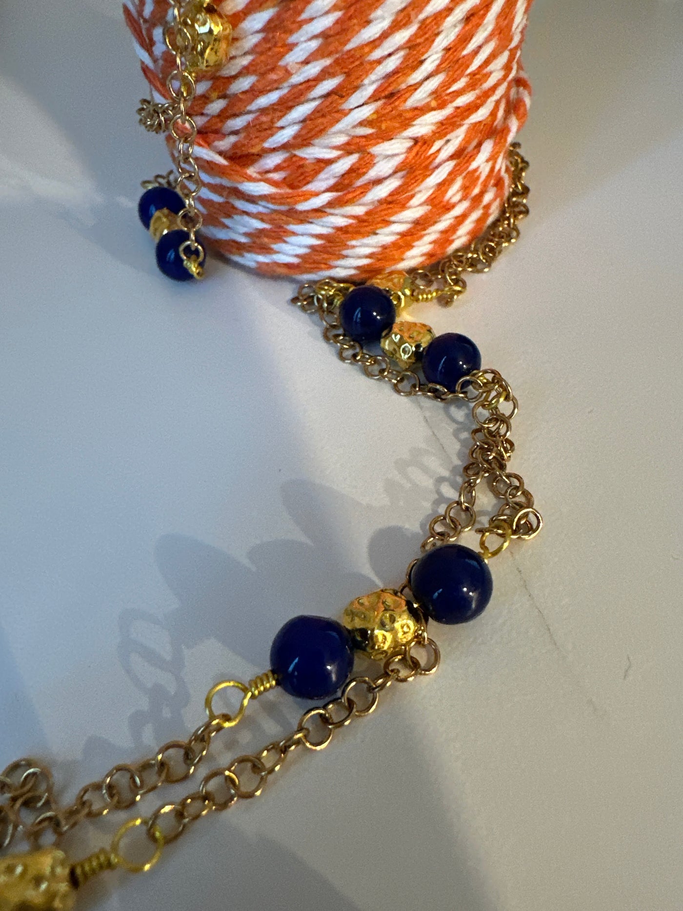 Blue giada on 'forzatina' steel gold chain and brass gold irregular elements. Long 98 cm