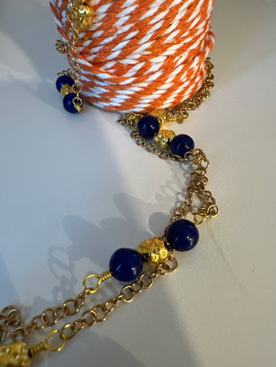 Blue giada on 'forzatina' steel gold chain and brass gold irregular elements. Long 98 cm