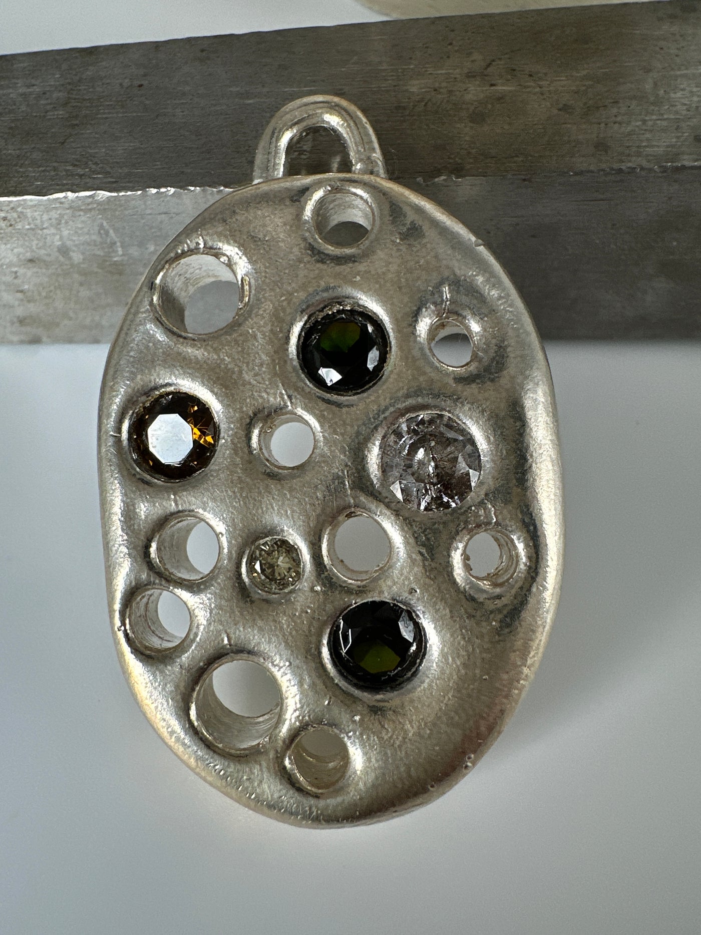 Lost wax silver pendant with encrusted gems