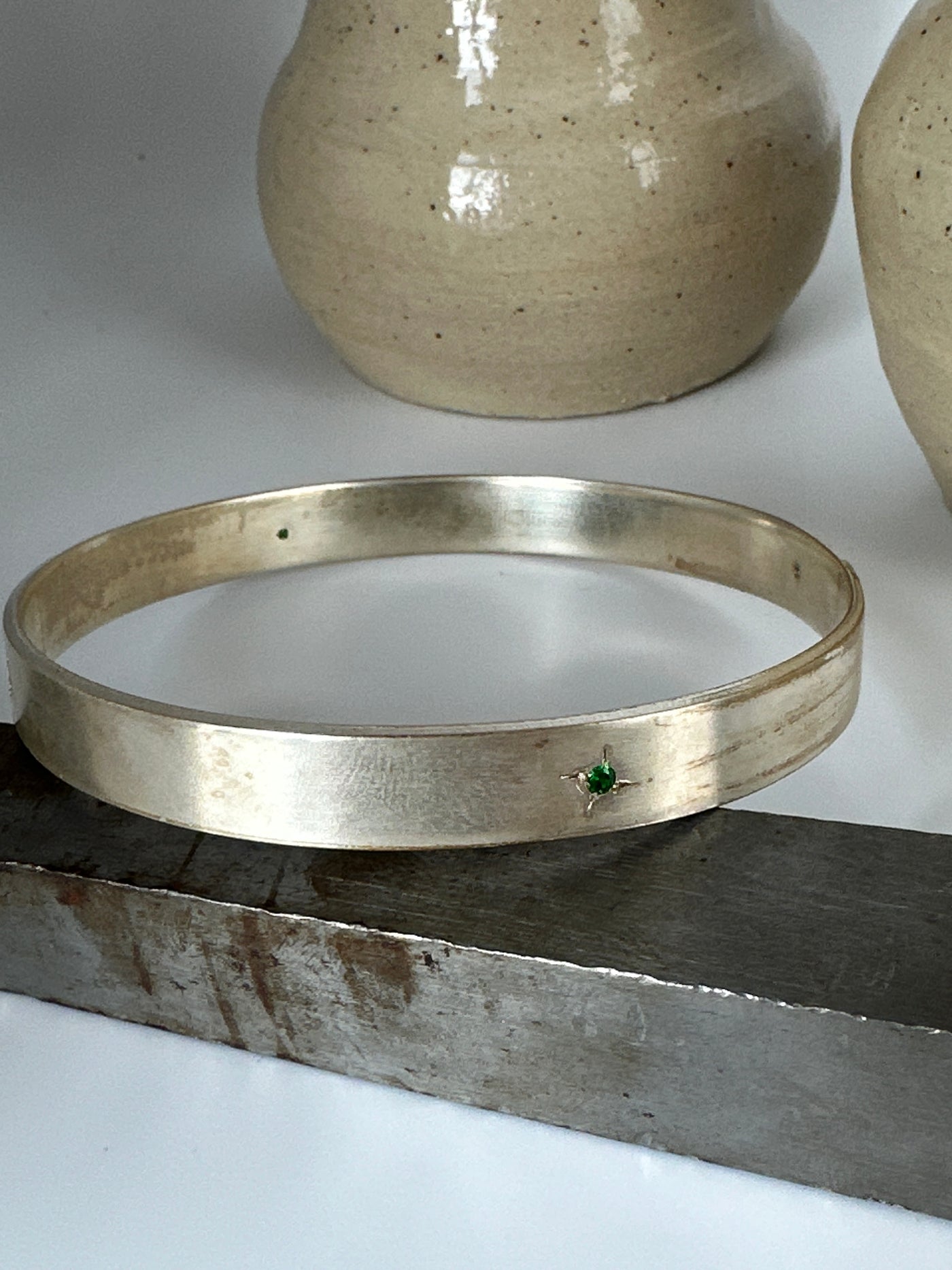 Silver solid bracelet with four cubic zirconias engraved