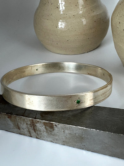 Silver solid bracelet with four cubic zirconias engraved