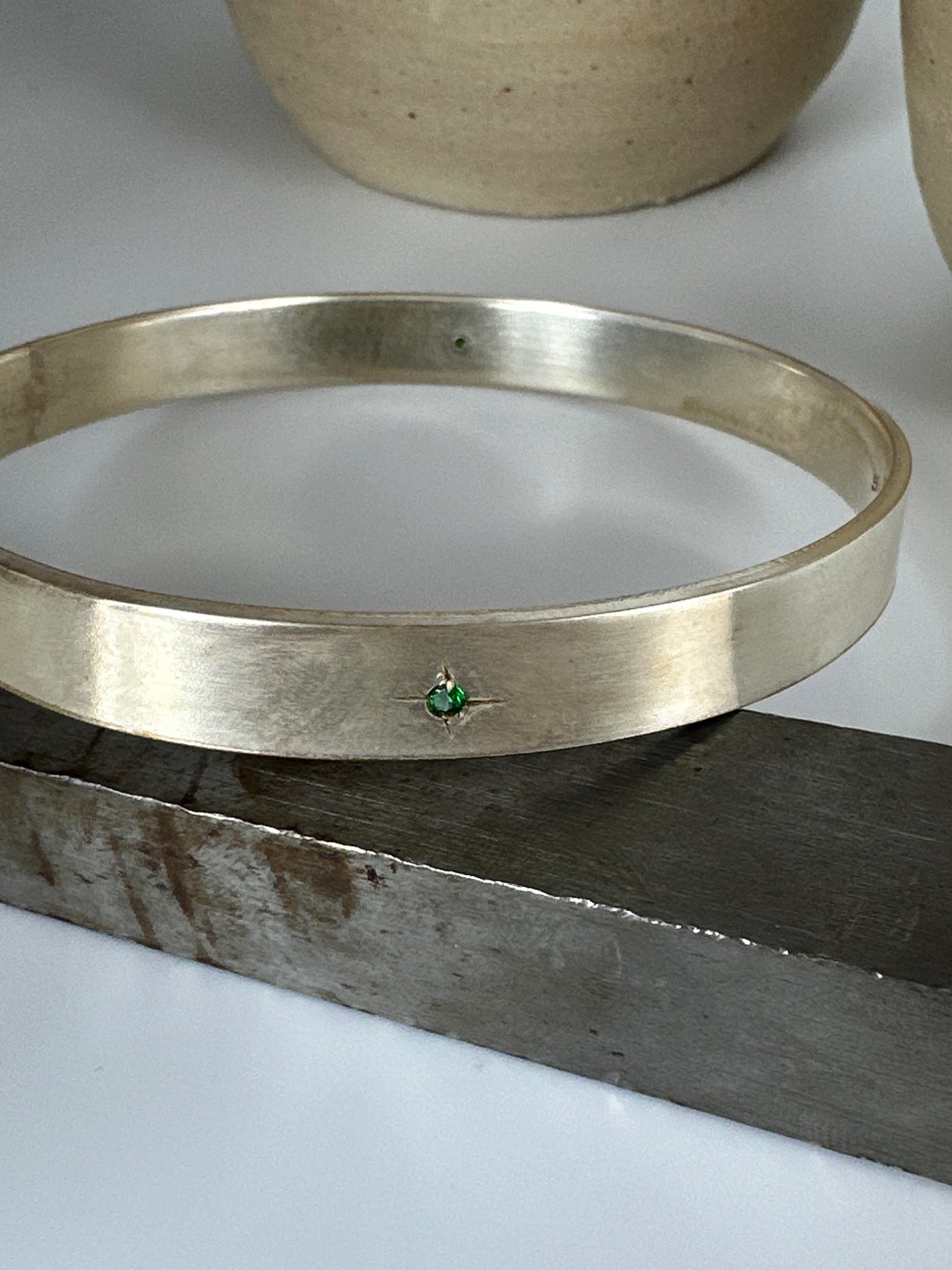 Silver solid bracelet with four cubic zirconias engraved