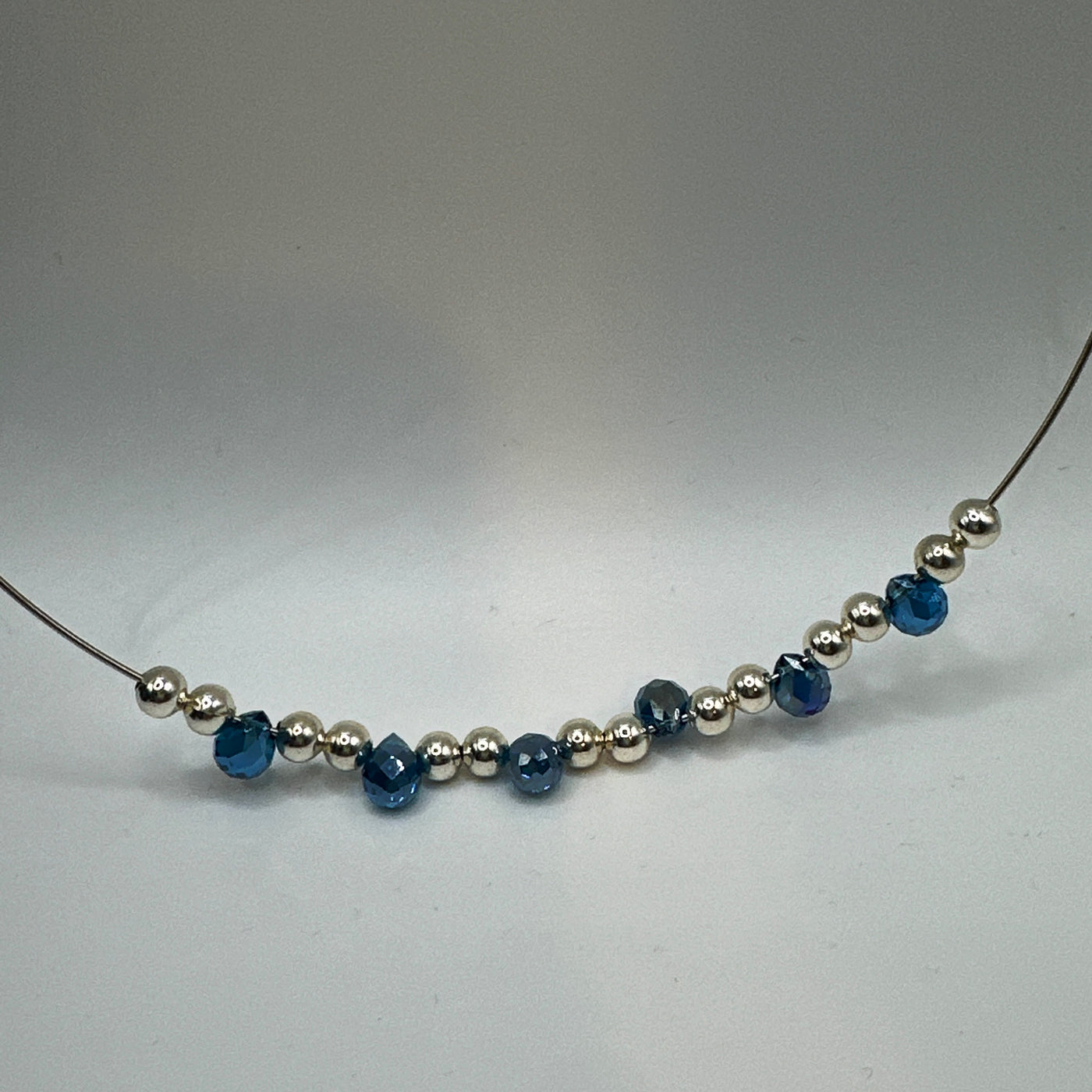 Round rigid necklace in steel with silver round brass and blue topaz briolette crystals elements