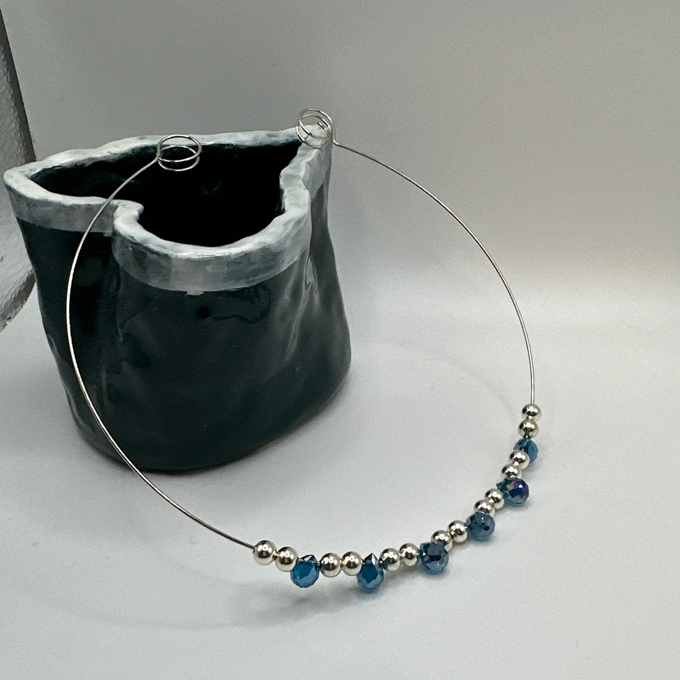 Round rigid necklace in steel with silver round brass and blue topaz briolette crystals elements