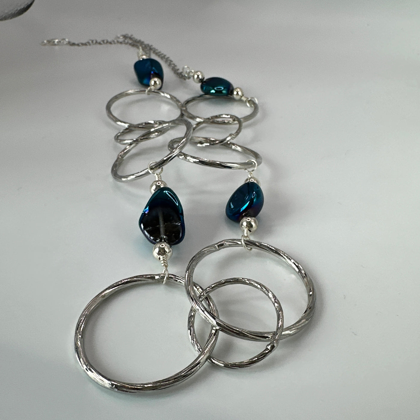 Round brass elements and 'burattato' and galvanized rock crystal peakok necklace