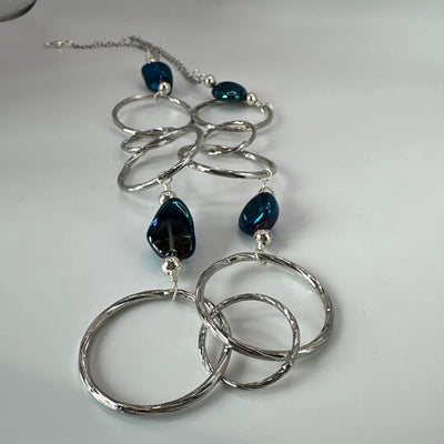 Round brass elements and 'burattato' and galvanized rock crystal peakok necklace