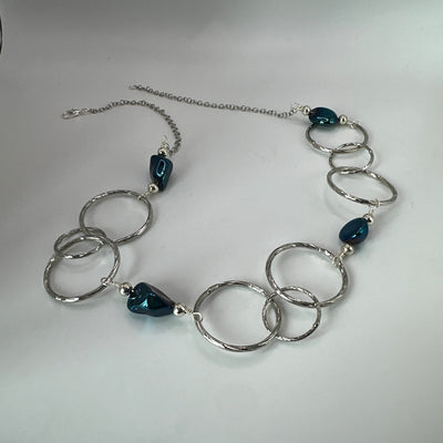 Round brass elements and 'burattato' and galvanized rock crystal peakok necklace
