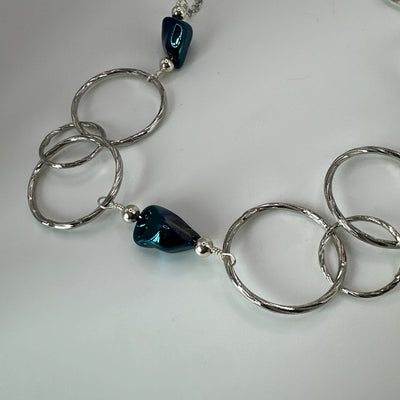 Round brass elements and 'burattato' and galvanized rock crystal peakok necklace