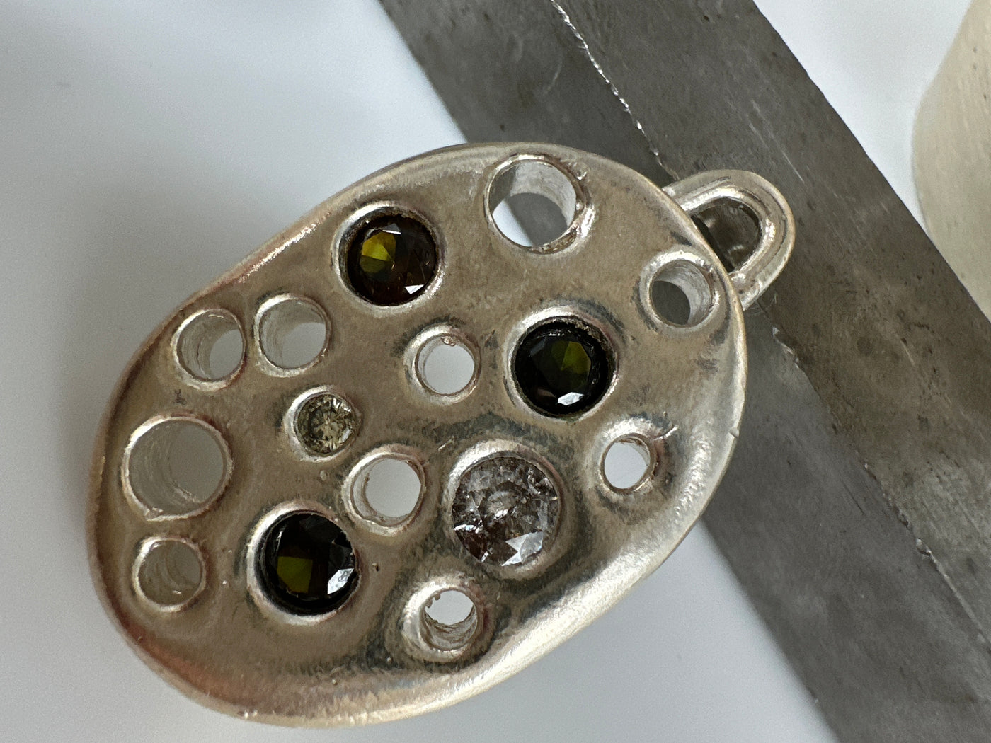 Lost wax silver pendant with encrusted gems